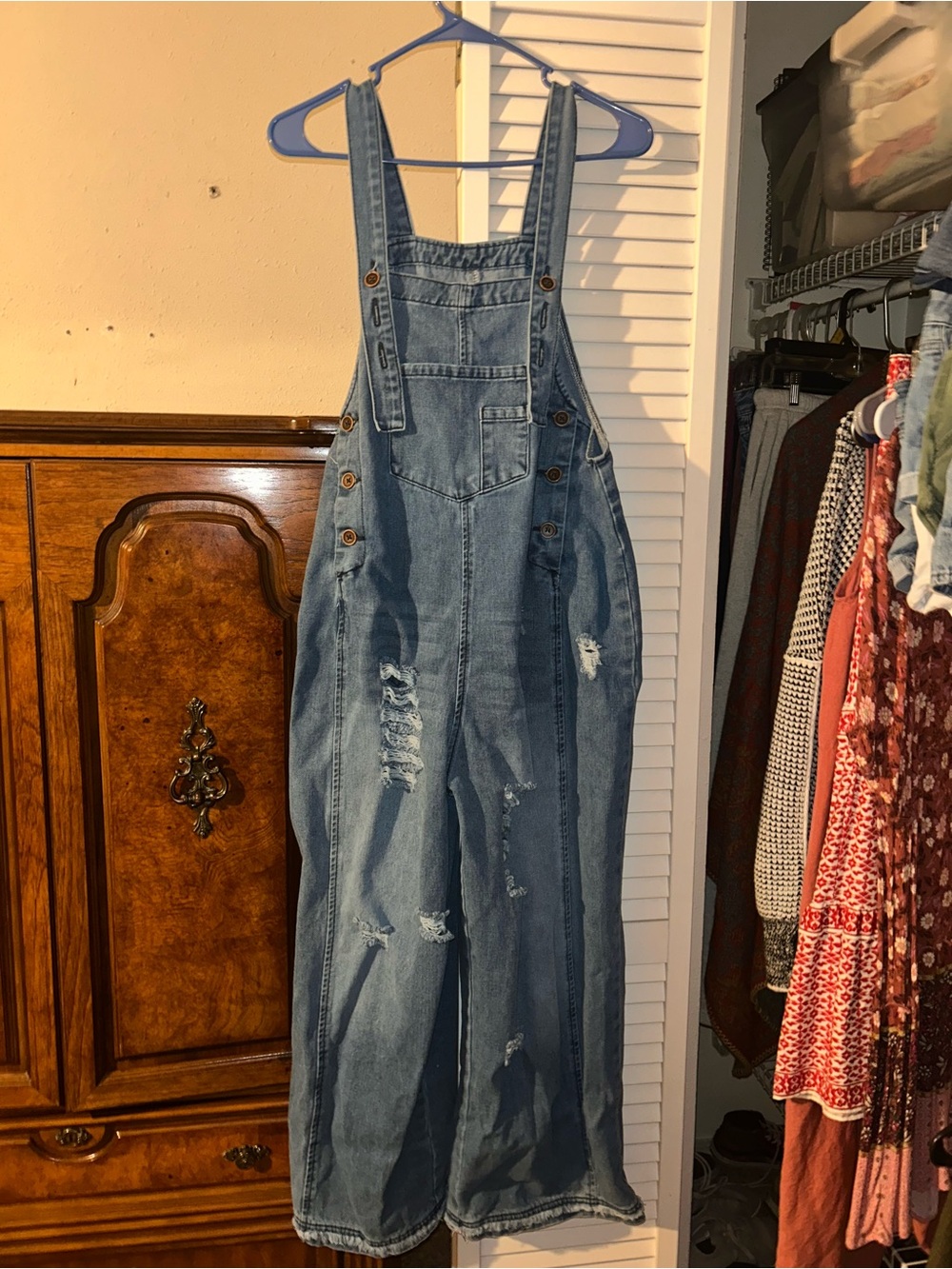Blue denim distressed overalls